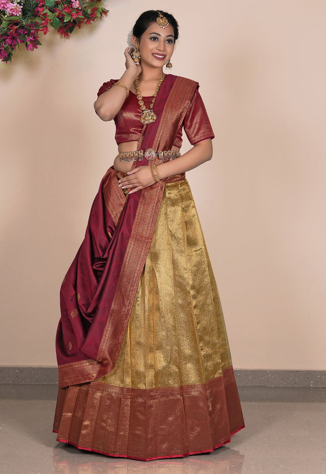 Woman wearing a traditional maroon and gold lehenga choli