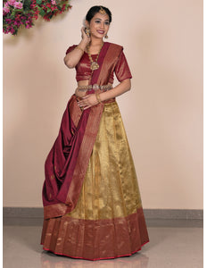 Woman wearing a traditional maroon and gold lehenga choli