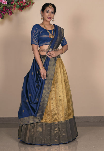 Woman wearing a traditional blue and gold lehenga choli