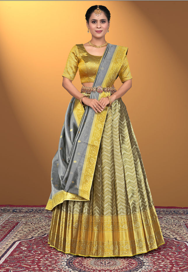 Woman wearing a yellow and gray traditional lehenga choli