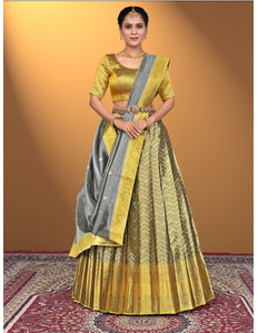 Woman wearing a yellow and gray traditional lehenga choli