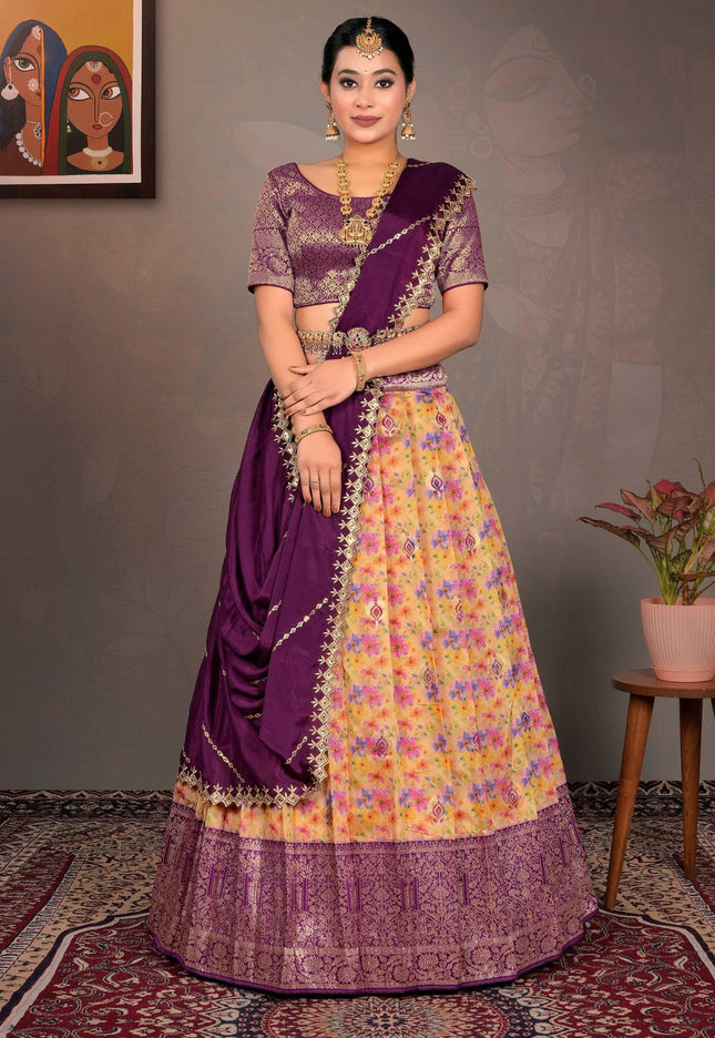 Woman wearing a traditional purple and yellow lehenga choli with a floral pattern