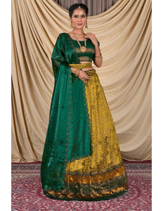 Woman wearing a green and yellow traditional lehenga choli with dupatta