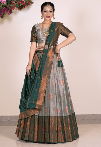 Woman wearing a traditional gray Lehenga with matching blouse and green dupatta