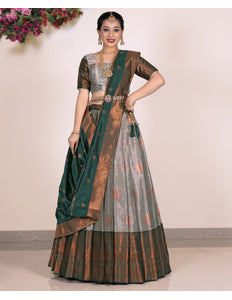 Woman wearing a traditional gray Lehenga with matching blouse and green dupatta