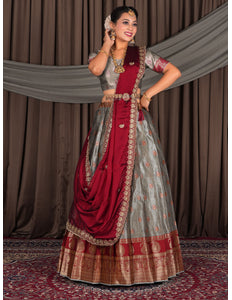 Woman in traditional red and gray lehenga choli