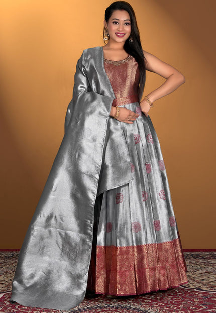 Woman wearing a gray and maroon gown with dupatta