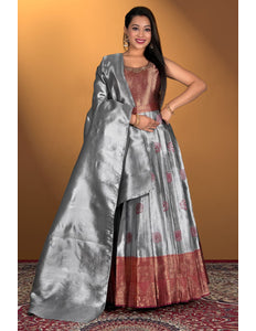 Woman wearing a gray and maroon gown with dupatta
