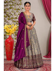 Woman wearing a traditional outfit with a purple dupatta