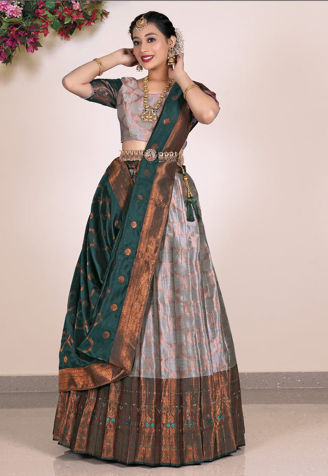 Woman wearing a traditional lehenga with a green and gray pattern