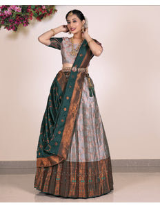 Woman wearing a traditional lehenga with a green and gray pattern