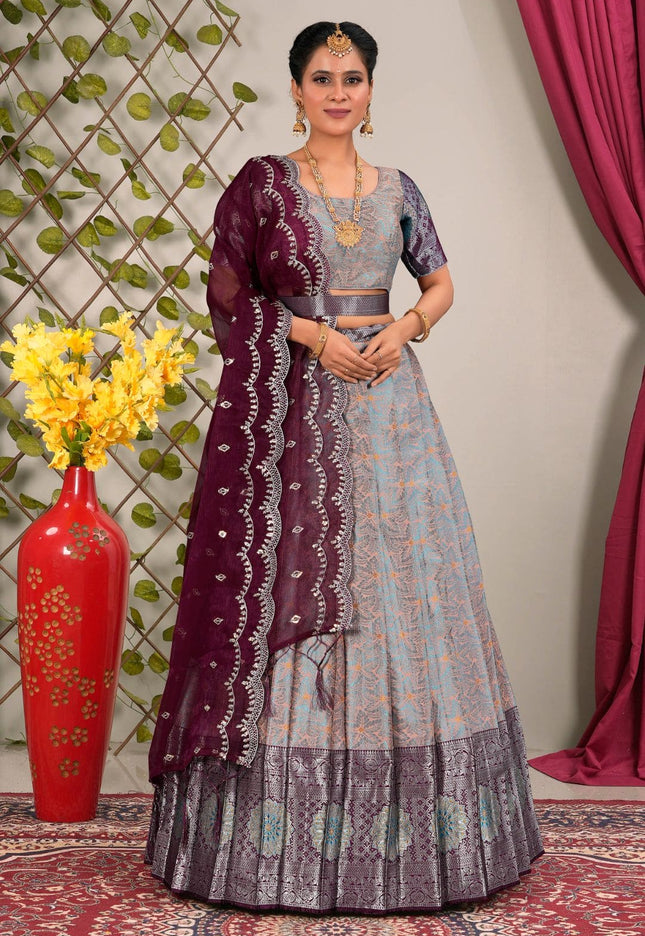 Woman wearing a traditional gray and purple lehenga choli with dupatta