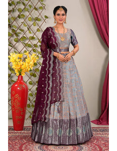 Woman wearing a traditional gray and purple lehenga choli with dupatta