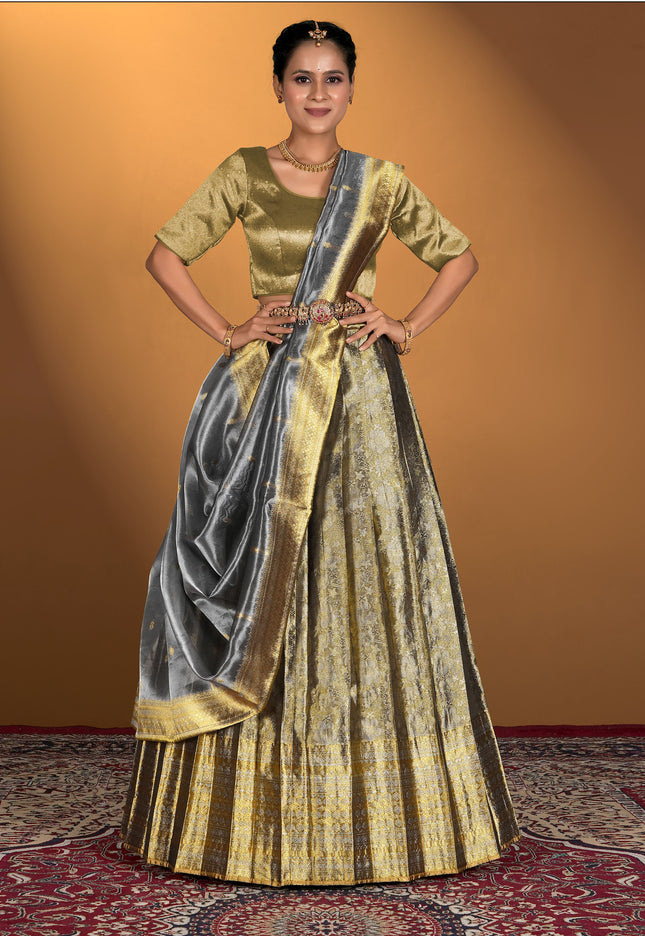 Woman wearing a traditional gold and gray lehenga choli