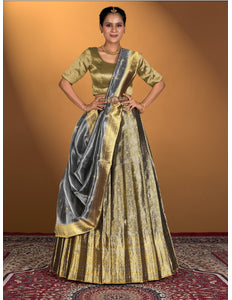 Woman wearing a traditional gold and gray lehenga choli