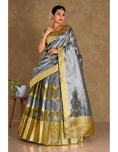Woman wearing a gray and gold lehenga choli with dupatta