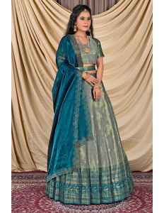 Woman wearing a traditional blue and green lehenga with a matching blouse