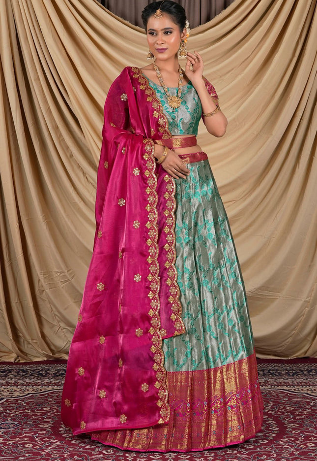 Woman wearing a traditional outfit with a pink dupatta and Gray lehenga