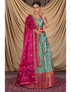 Woman wearing a traditional outfit with a pink dupatta and Gray lehenga