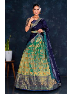 Woman wearing a traditional blue and green lehenga choli with dupatta