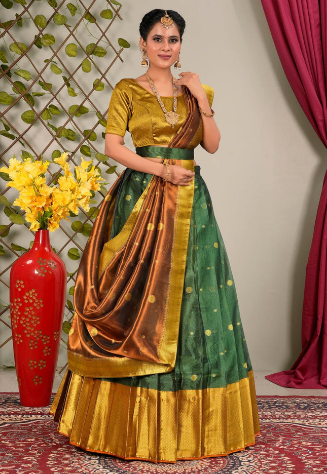 Woman wearing a green and gold traditional outfit