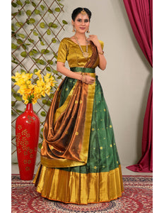 Woman wearing a green and gold traditional outfit