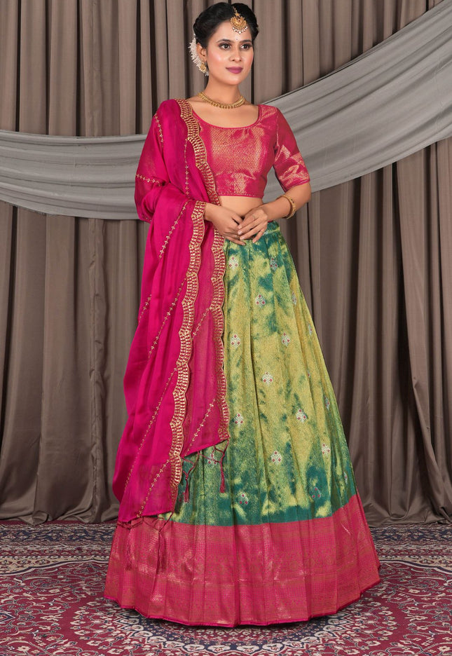 Woman wearing a traditional pink and green lehenga choli