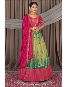 Woman wearing a traditional pink and green lehenga choli