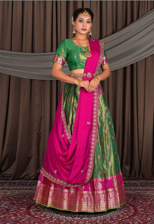 Woman wearing a traditional green and pink lehenga choli with dupatta
