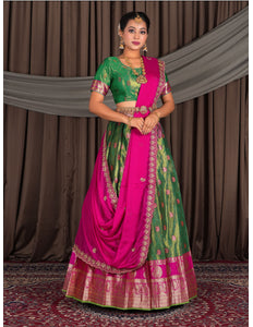 Woman wearing a traditional green and pink lehenga choli with dupatta