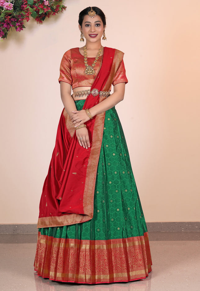Woman wearing a traditional green Lehenga with a red blouse
