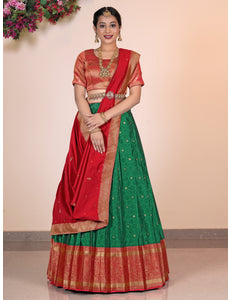 Woman wearing a traditional green Lehenga with a red blouse
