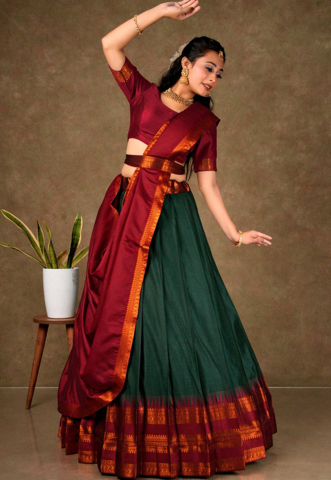 Woman in a traditional maroon and green lehenga choli with dupatta