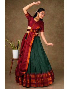 Woman in a traditional maroon and green lehenga choli with dupatta