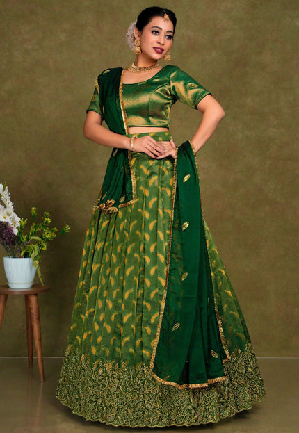 Woman wearing a green traditional outfit with gold patterns
