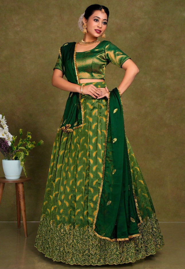 Woman wearing a green traditional outfit with gold patterns
