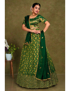 Woman wearing a green traditional outfit with gold patterns