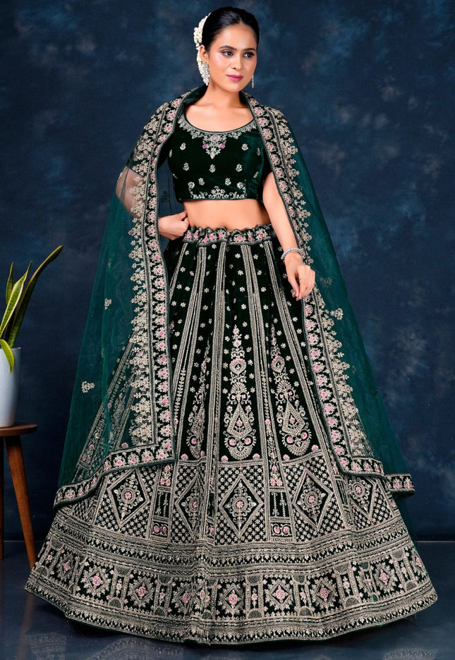 Woman wearing a traditional green embroidered lehenga choli with dupatta