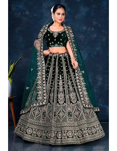 Woman wearing a traditional green embroidered lehenga choli with dupatta