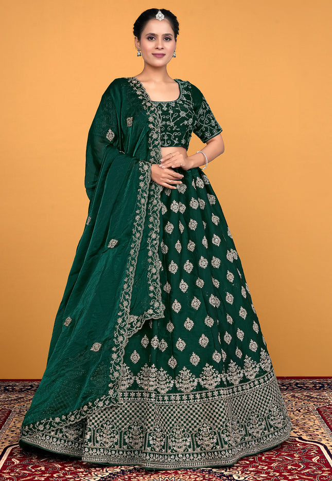 Woman wearing a green embroidered traditional lehenga choli
