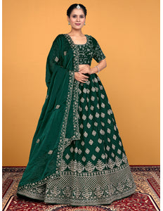 Woman wearing a green embroidered traditional lehenga choli