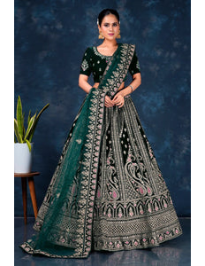 Woman wearing a traditional embroidered outfit with a green dupatta