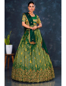 Woman wearing a green traditional outfit with gold embroidery
