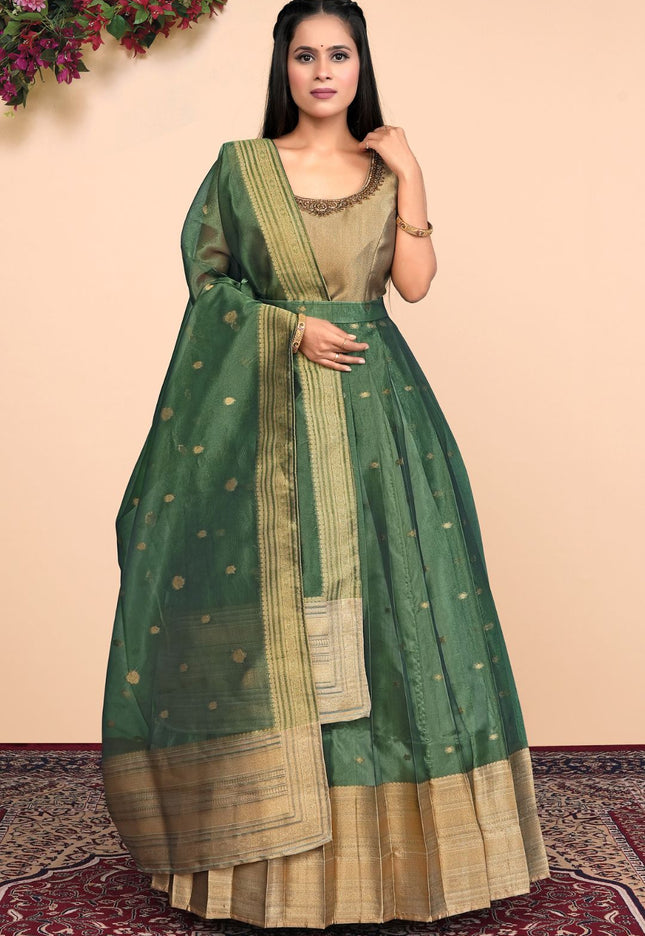 Woman wearing a green and beige traditional outfit