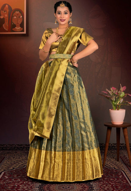 Woman in a traditional green and gold lehenga choli  with dupatta