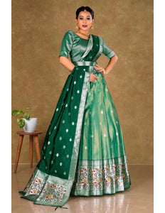 Woman wearing a green lehenga choli with a patterned border