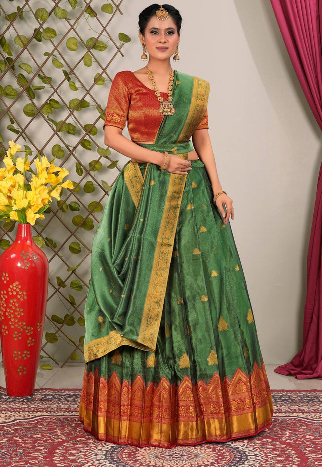 Woman wearing a green and Red lehenga choli with dupatta