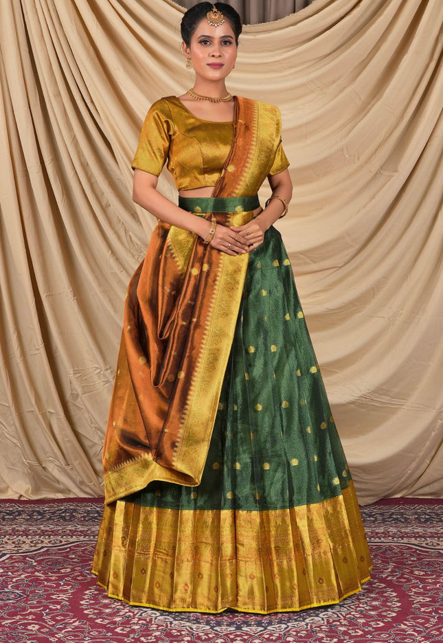 Woman wearing a traditional green and gold lehenga choli with dupatta
