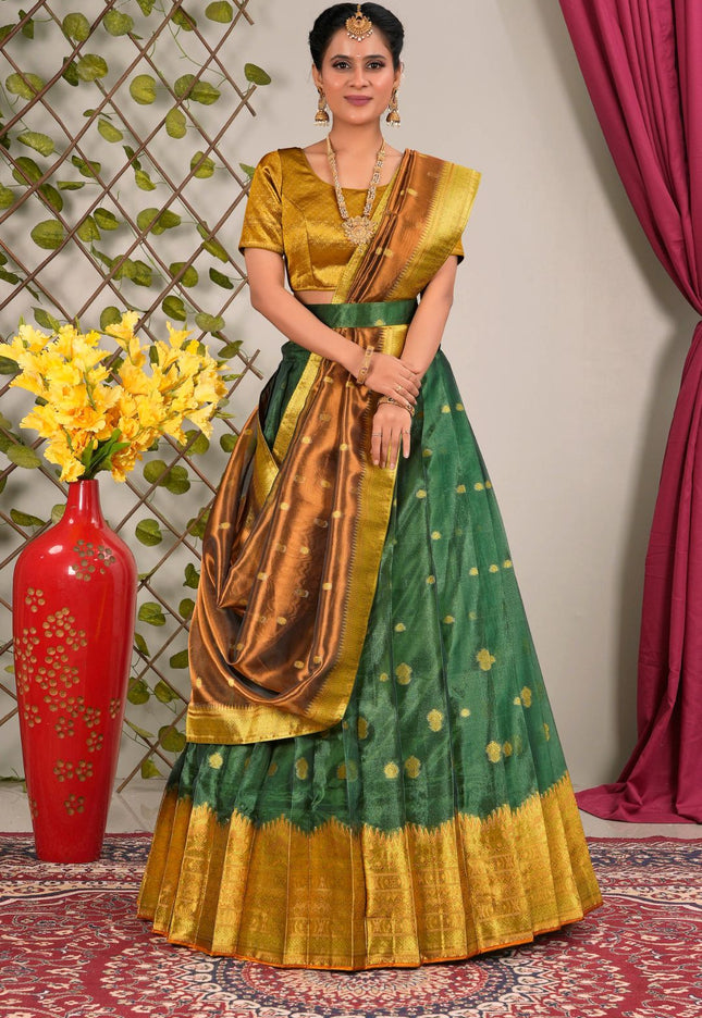 Woman in a green and gold traditional lehenga choli with dupatta