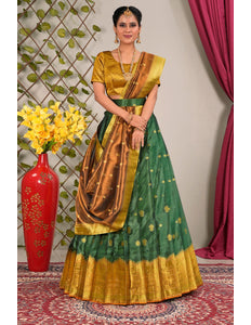 Woman in a green and gold traditional lehenga choli with dupatta